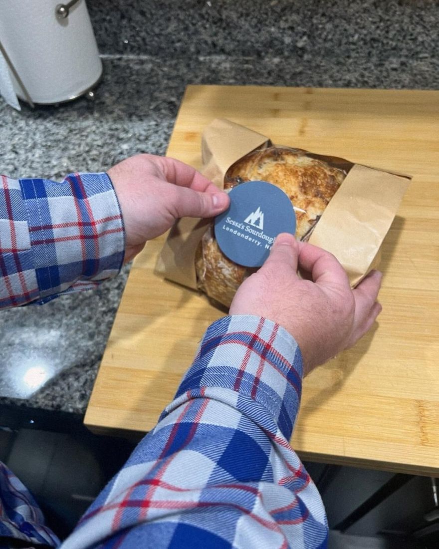 Gary placing the first label on the first loaf sold